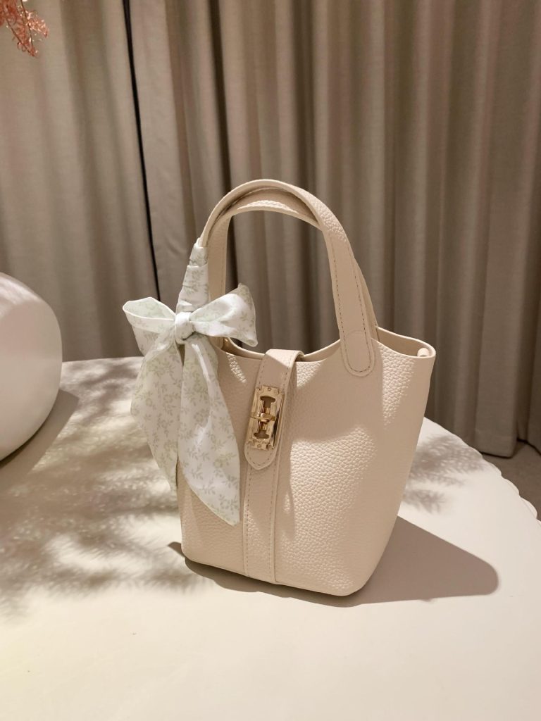 Ladies' small travel handbag with elegant bow design