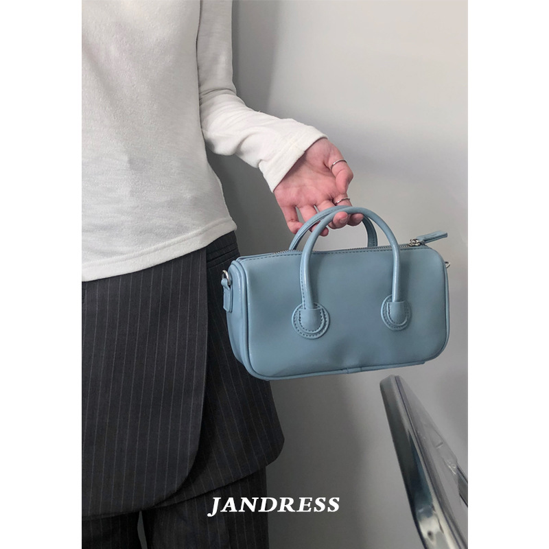 The lady is holding a colorful bag